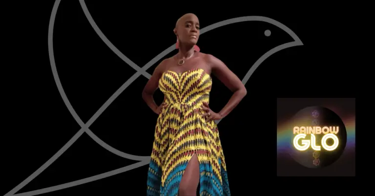 A rectangular graphic with a black background featuring the grey outline of the Lark bird logo. In the centre-left stands a woman wearing a strapless, brightly patterned dress in yellow, red and blue, posing confidently with her hands on her hips. She has a shaved head and is wearing a circular necklace and large earrings. On the lower right of the image is the Rainbow Glo logo, which shows glowing, rainbow-coloured text reading “Rainbow Glo” set against a dark circular background with subtle rainbow light around the edges.