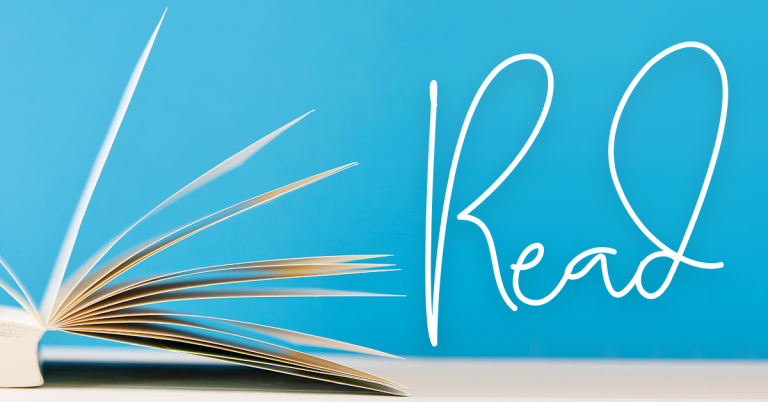 An open book lies on a flat surface with its pages fanned out to the left. The background is a bright blue, and the word “Read” is written in large white script on the right side of the image.